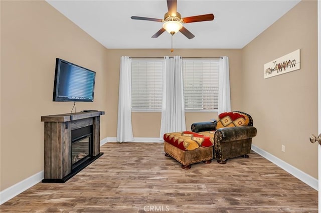 living area featuring ceiling fan and hardwood / wood-style floors