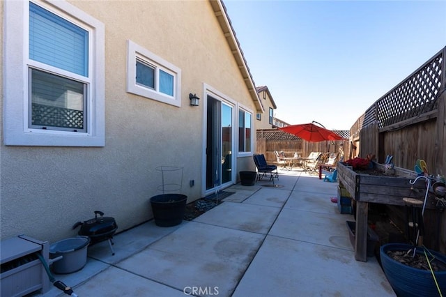 view of side of home featuring a patio