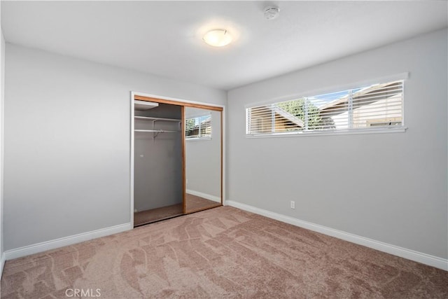 unfurnished bedroom featuring a closet and carpet flooring