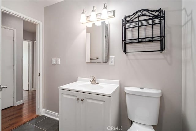 bathroom featuring toilet, vanity, and tile patterned floors