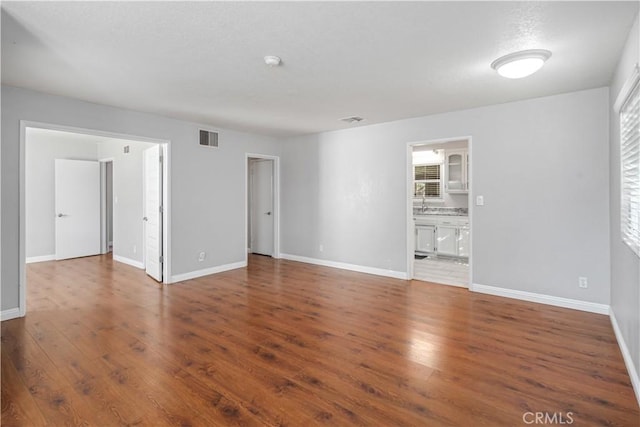 unfurnished room featuring dark wood-type flooring