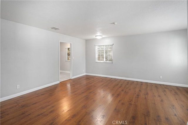 empty room featuring dark wood-type flooring