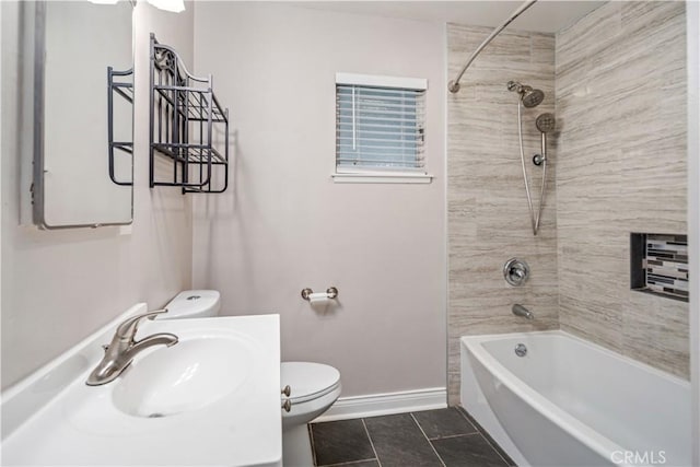 full bathroom featuring tile patterned floors, toilet, tiled shower / bath, and vanity