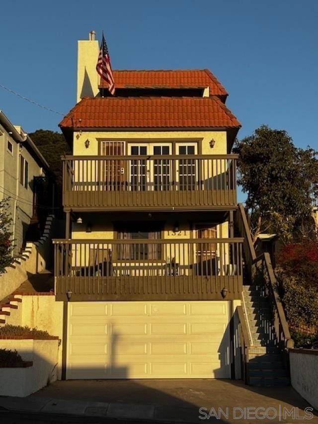 view of front of property with a balcony and a garage