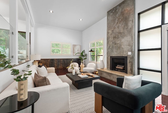 living room with wood-type flooring and a fireplace