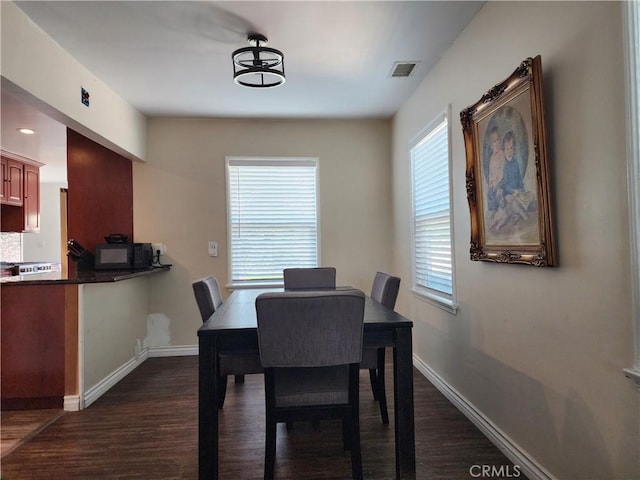 dining room with dark hardwood / wood-style floors