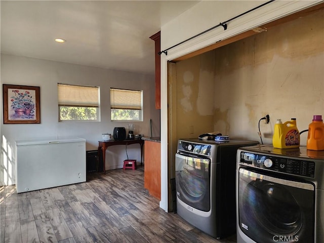 washroom featuring dark wood-type flooring and separate washer and dryer