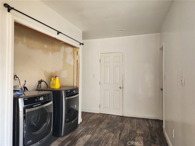 laundry room featuring washing machine and dryer and dark wood-type flooring