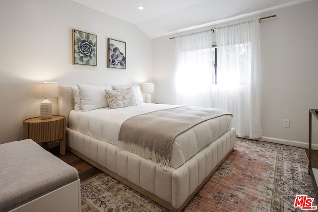 bedroom featuring vaulted ceiling and wood-type flooring