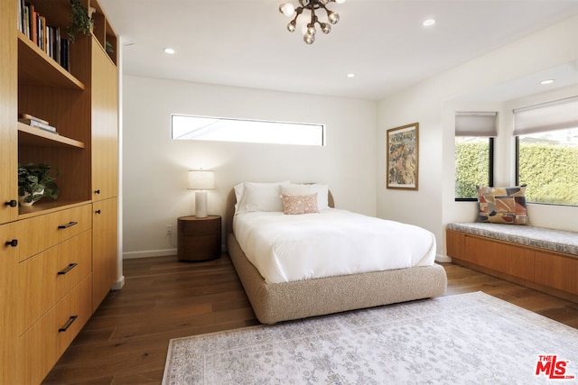 bedroom with dark hardwood / wood-style flooring