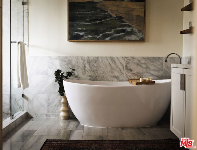 bathroom with independent shower and bath and tile walls