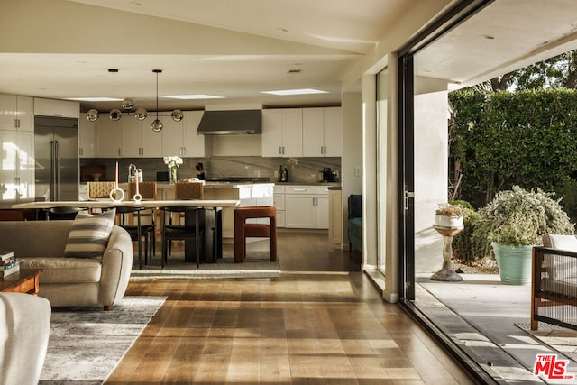 interior space featuring dark wood-type flooring and lofted ceiling