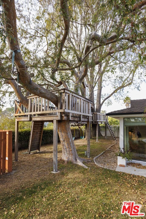 view of yard featuring a playground and a deck