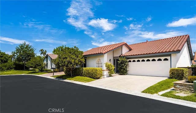 mediterranean / spanish-style house with a garage