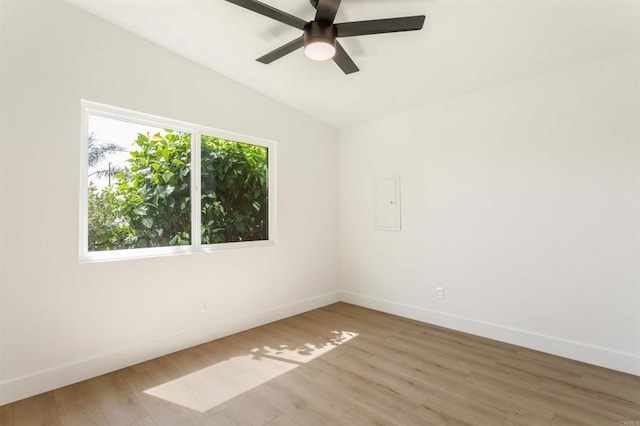 empty room with vaulted ceiling, ceiling fan, and hardwood / wood-style floors