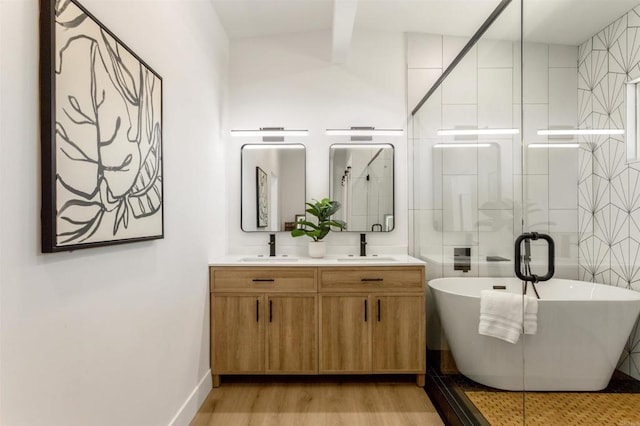 bathroom featuring independent shower and bath, wood-type flooring, and vanity