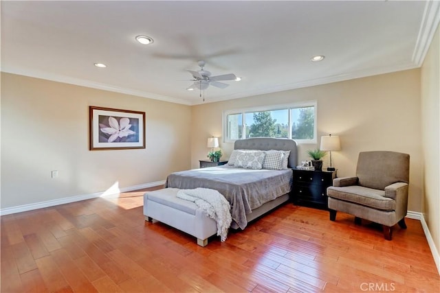 bedroom featuring ceiling fan, crown molding, and hardwood / wood-style flooring