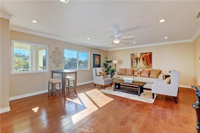 living room with ceiling fan, ornamental molding, and hardwood / wood-style flooring