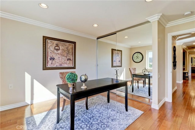 office area featuring hardwood / wood-style flooring and crown molding