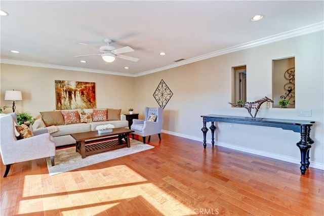 living room with ceiling fan, ornamental molding, and hardwood / wood-style floors