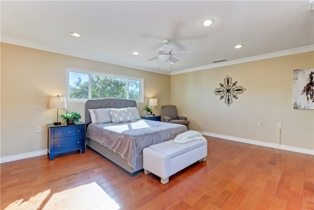 bedroom with ceiling fan, hardwood / wood-style flooring, and crown molding