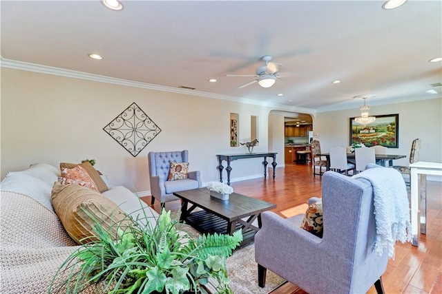 living room featuring ceiling fan, ornamental molding, and hardwood / wood-style floors