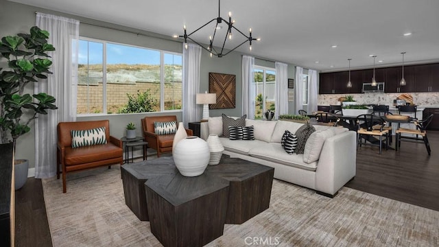 living room featuring an inviting chandelier and light wood-type flooring