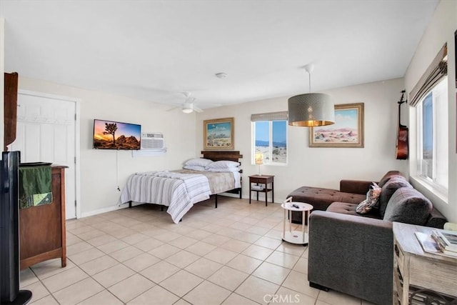 tiled bedroom with a wall unit AC and ceiling fan