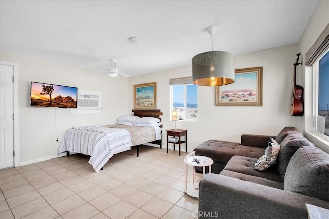 bedroom with ceiling fan, light tile patterned floors, and a wall mounted AC