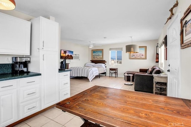 tiled bedroom featuring ceiling fan