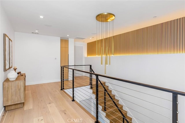 corridor with light hardwood / wood-style floors