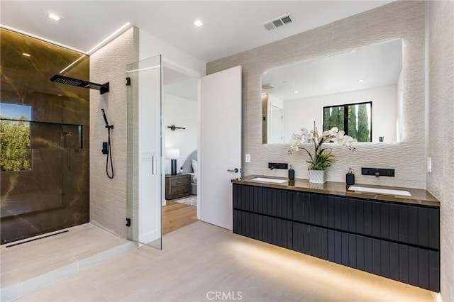 bathroom with walk in shower and vanity