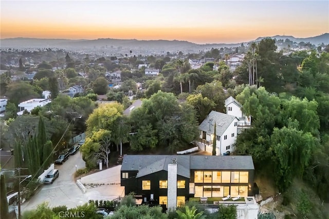 aerial view at dusk featuring a mountain view