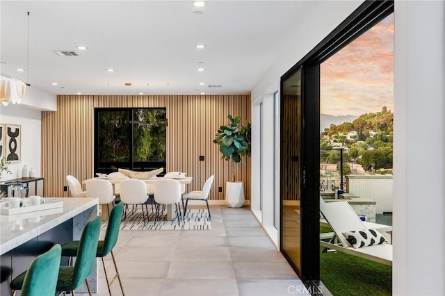 dining area featuring wood walls