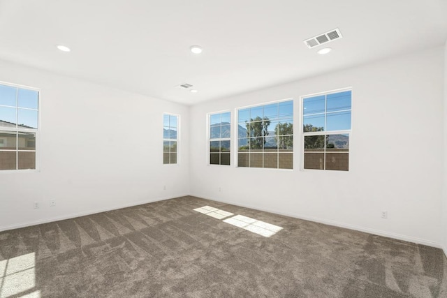 unfurnished room with dark carpet