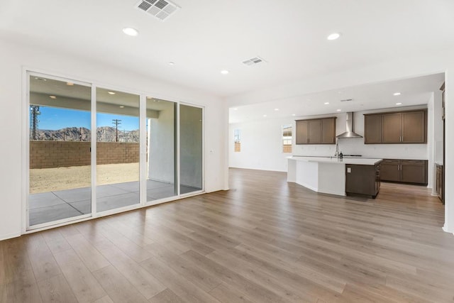 unfurnished living room with wood-type flooring