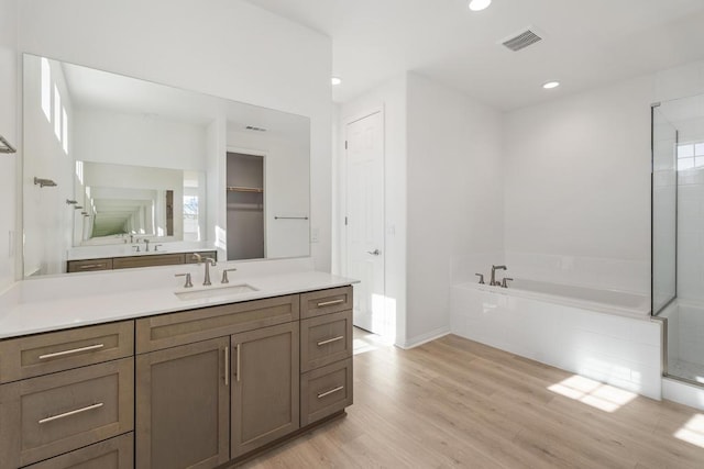 bathroom with separate shower and tub, vanity, a healthy amount of sunlight, and hardwood / wood-style flooring