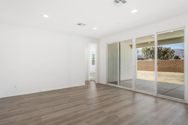 empty room with hardwood / wood-style floors