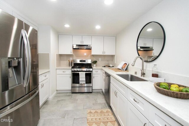 kitchen featuring sink, white cabinetry, appliances with stainless steel finishes, and light tile patterned flooring