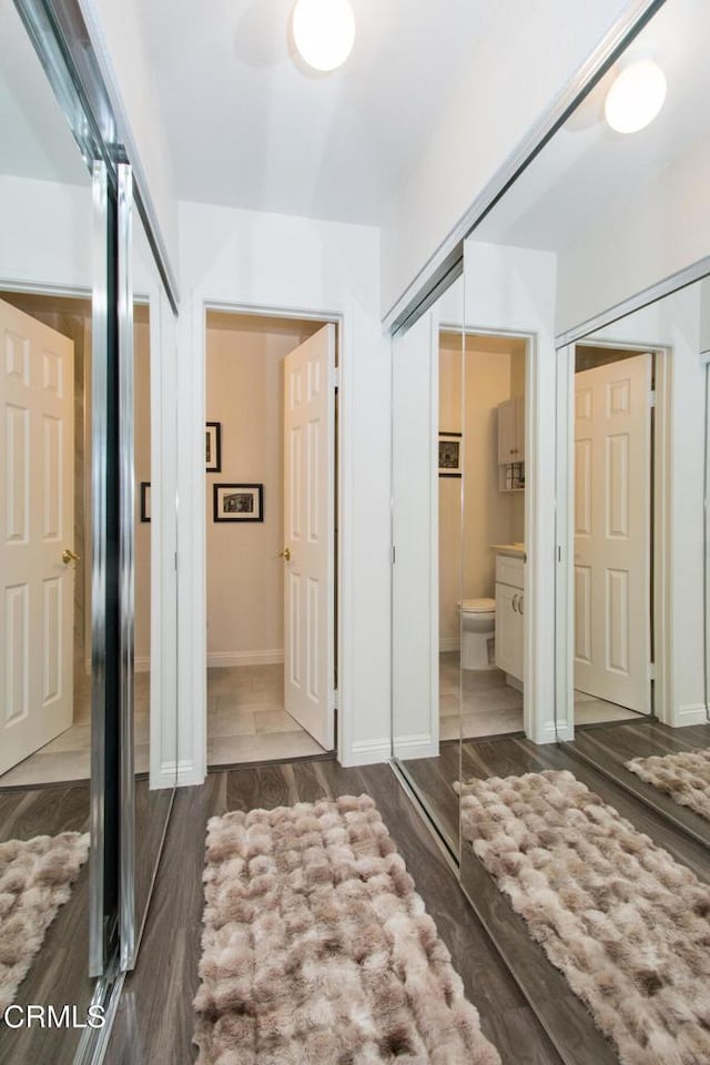 bathroom featuring toilet, vanity, and hardwood / wood-style floors