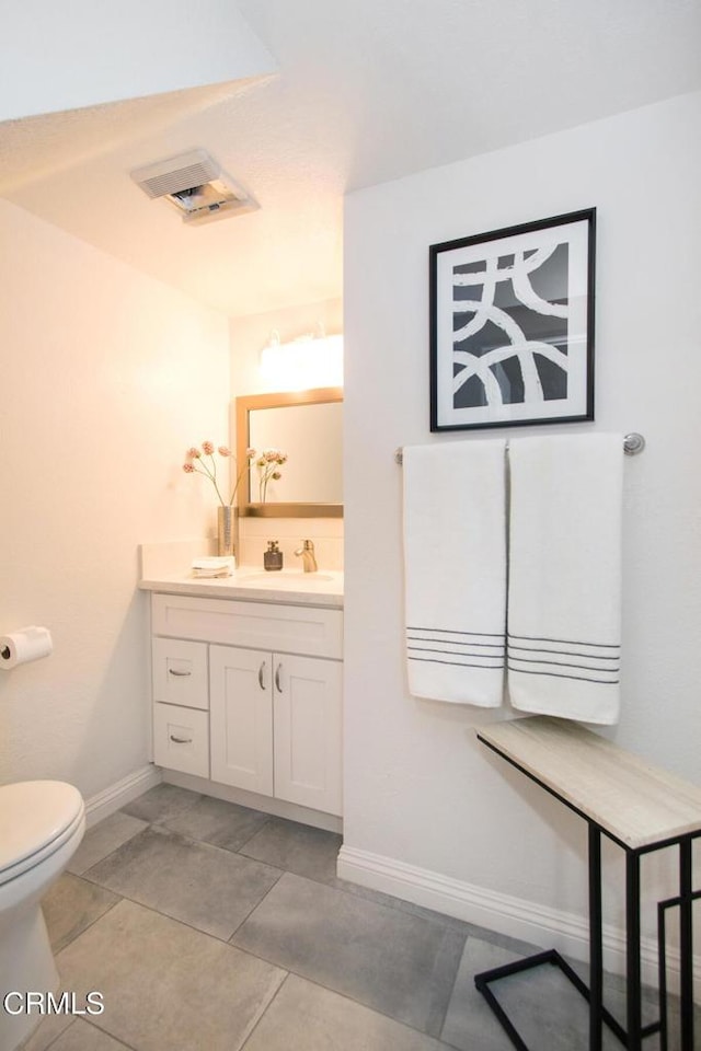 bathroom featuring tile patterned floors, toilet, and vanity