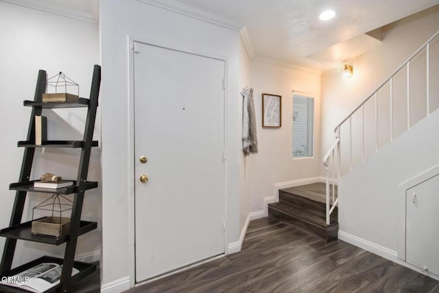 entryway with dark hardwood / wood-style flooring and ornamental molding