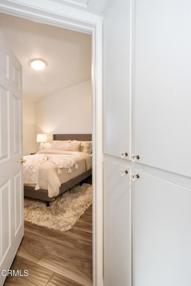 bedroom with hardwood / wood-style flooring