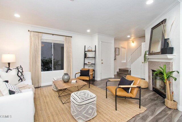 living room featuring hardwood / wood-style floors and crown molding