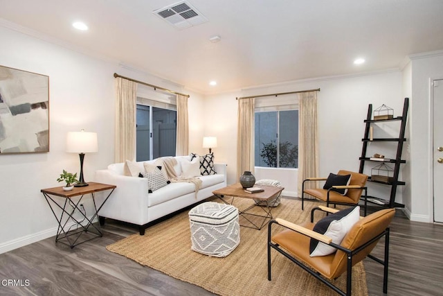 living room with dark wood-type flooring and ornamental molding