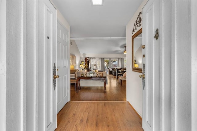 foyer featuring lofted ceiling, ceiling fan, and light hardwood / wood-style floors