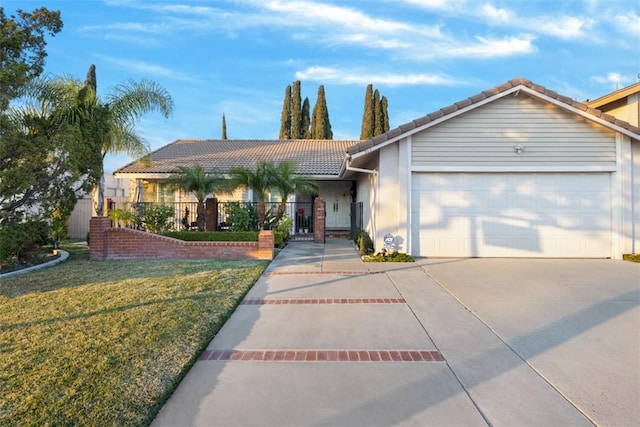 ranch-style house featuring a front lawn and a garage