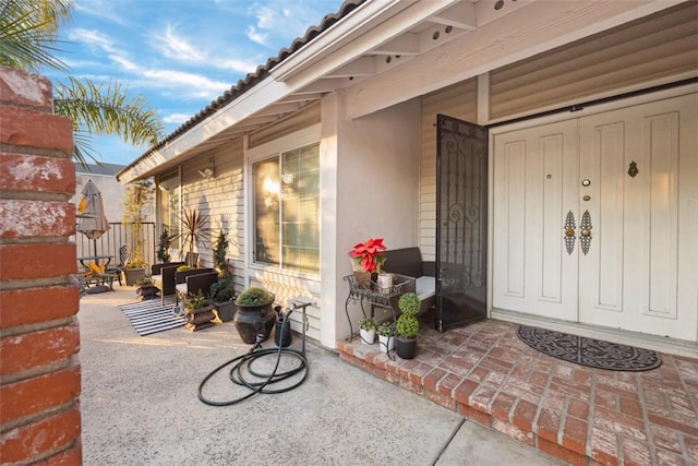 doorway to property featuring covered porch