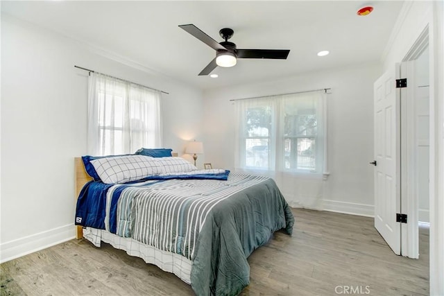 bedroom featuring ceiling fan and light hardwood / wood-style floors