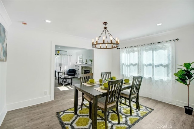 5737 5th, Los Angeles, CA 90043 - dining space featuring wood finished floors, a chandelier, a wall mounted AC, baseboards, and recessed lighting